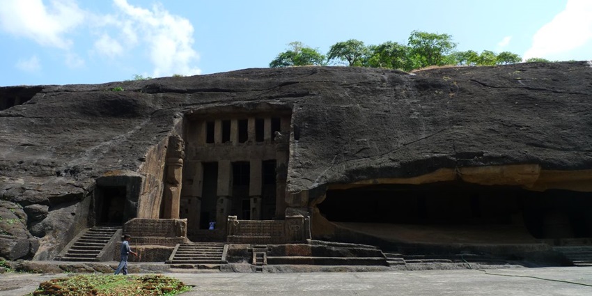 A large rock-cut Buddhist cave with arched entrances and intricate carvings at Kanheri.
