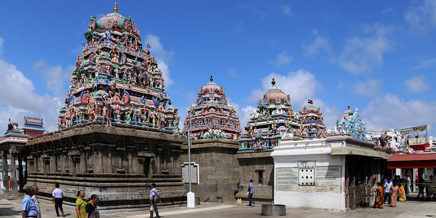 People walking in the beautiful corridors of the temple premises for travellers.