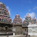 Intricate temple interior with detailed carvings, colorful pillars, and soft lighting in Chennai