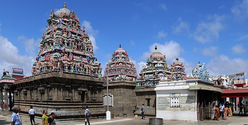 Intricate temple interior with detailed carvings, colorful pillars, and soft lighting in Chennai