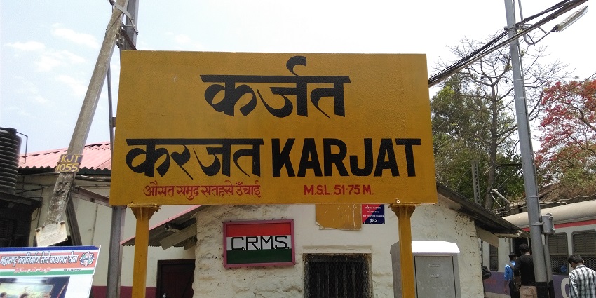 Karjat railway station showing station board.