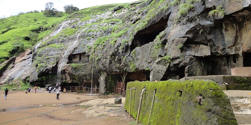 A valley nestled between towering mountains, a popular destination near Maharashtra.