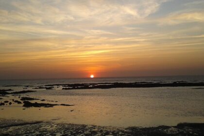 A picturesque sunset at Kashid Beach, showcasing vibrant hues reflecting on the water