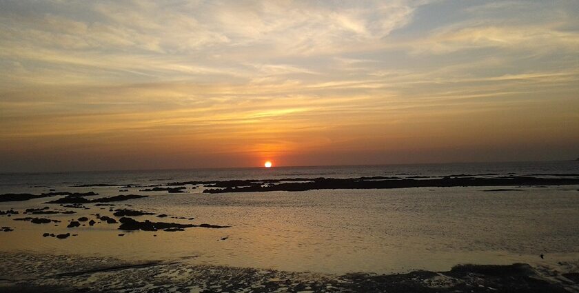 A picturesque sunset at Kashid Beach, showcasing vibrant hues reflecting on the water