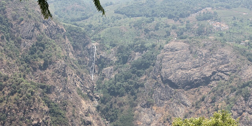 View of Katery Falls surrounded by greenery in Coonoor.