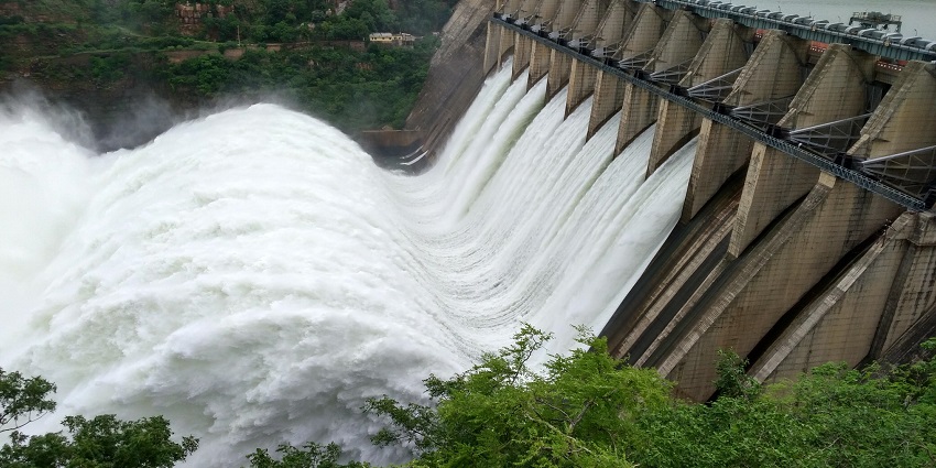 The image shows water flowing over a dam in the background, captured from a distance near Katepurna wildlife sanctuary.