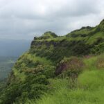 A view of a famous tourist attraction in Maharashtra surrounded by lush greenery.