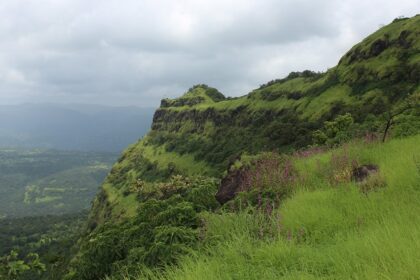 A view of a famous tourist attraction in Maharashtra surrounded by lush greenery.