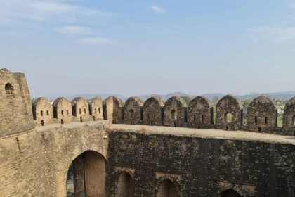 Scenic view of Kavnai Fort surrounded by greenery under a clear blue sky