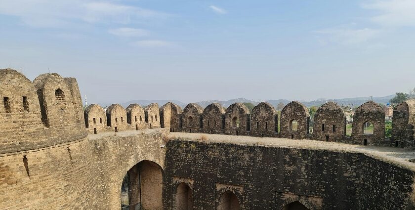 Scenic view of Kavnai Fort surrounded by greenery under a clear blue sky