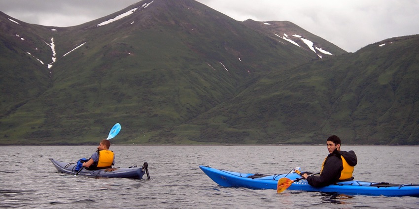 A picture showing two kayakers enjoying kayaking in the still waters of a lake around Kanakapura