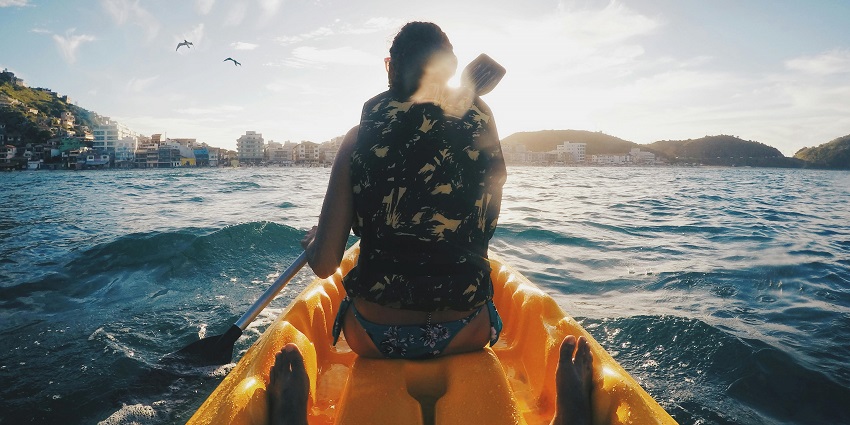 An image of a kayaker paddling on the calm waters, one of the best water sports near Pune.