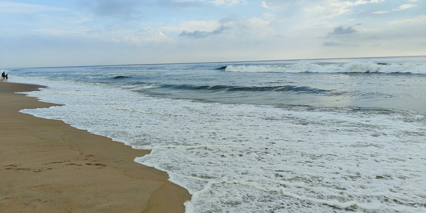 Tranquil Kelshi Beach with soft sands and gentle waves, perfect for a peaceful retreat.