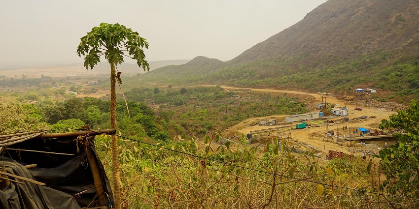 A serene landscape featuring a mountain range under a cloudy sky and various pathways.