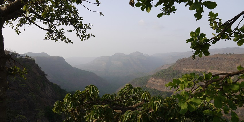 An image of the lush green hills and waterfalls in Khandala during the monsoon.