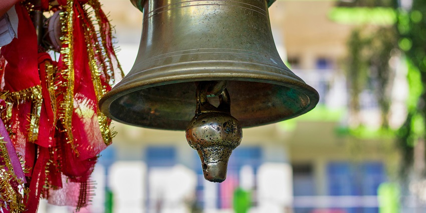 A temple bell at historic temple is known for vibrant festivals and architecture.