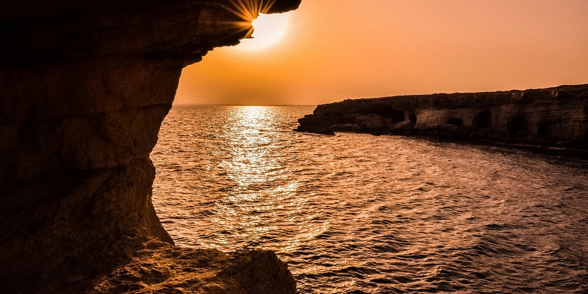 A placid water body surrounded by rock formations, a popular destination near Udgir Fort.