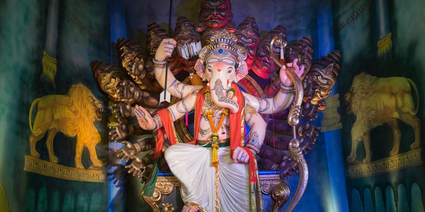 Colorful Ganesh murti with eight hands displayed during festive celebration