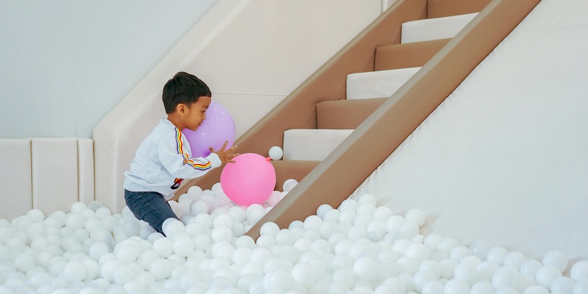 A cute little boy joyfully enjoy games at KidZania - one of the theme parks in Thane.