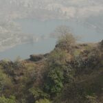 Panoramic landscape seen from Kohoj Fort, showcasing a scenic view of lakes and hills.