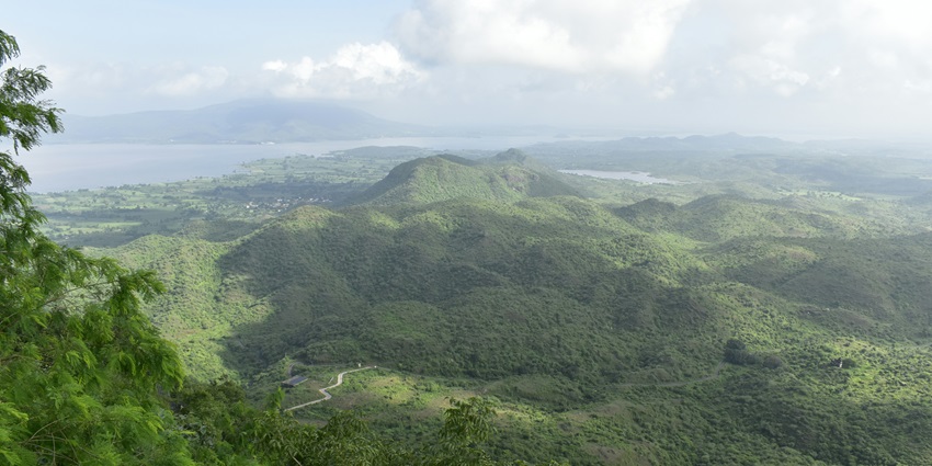 Picturesque view of the verdant hills of Kolad with clouds looming over.