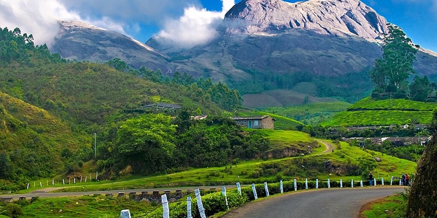 An image of Kolli Hills, a hill station near Chennai, with mist-covered peaks and waterfalls.