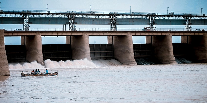 Koyna Dam, showcasing the large structure and surrounding green landscape.