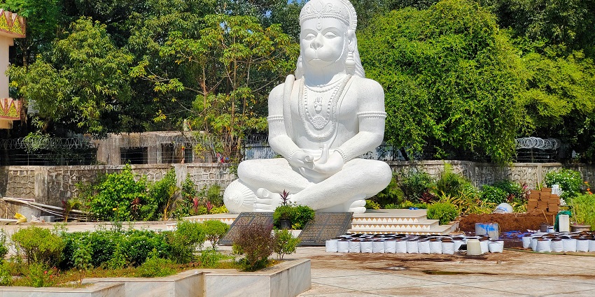 A statue of lord Hanuman in a sitting posture, located outside a temple in Navi Mumbai