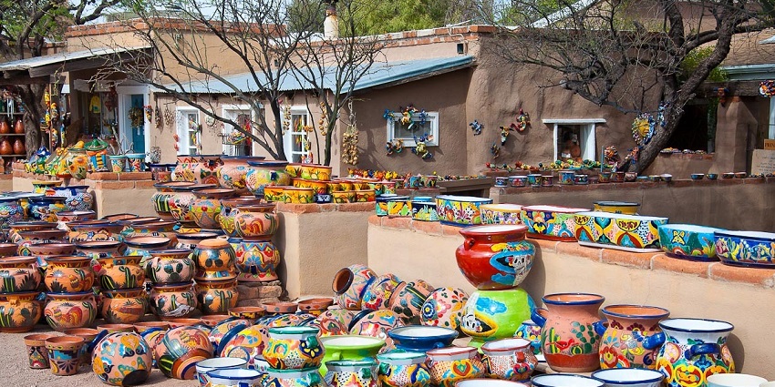 Street view of Kumbharwada Road, with vendors selling colorful pots