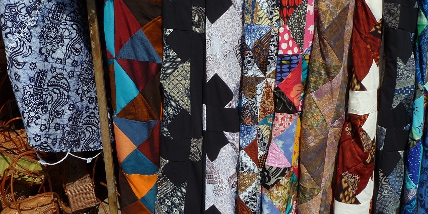 Colourful costume materials and traditional Balinese textiles for sale in the Bali market.