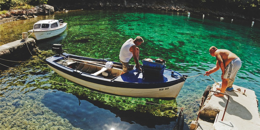 Relaxing lagoon fishing, casting lines in calm, one of the Lakshadweep water sports.