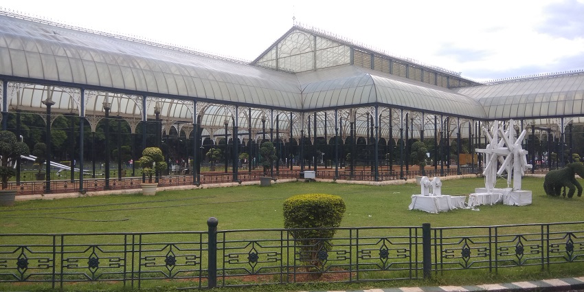The famous places to visit in Bangalore with family feature Lalbagh, the botanical paradise with diverse plants