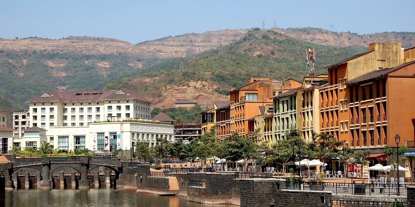 A scenic view of Lavasa City surrounded by hills, a popular tourist destination near Tamhini Waterfall.