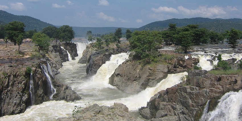 Places to visit near Coonoor - a waterfall nestled in lush greenery, perfect for photography.