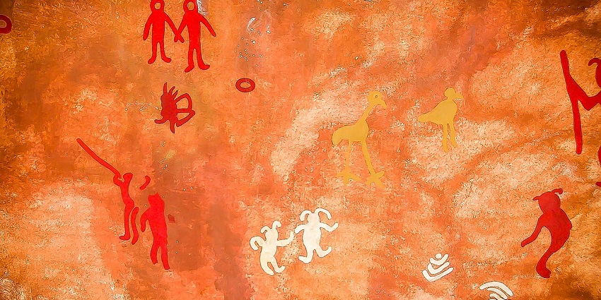 An outer wall of the cave is painted with different sorts of paintings in red colour.