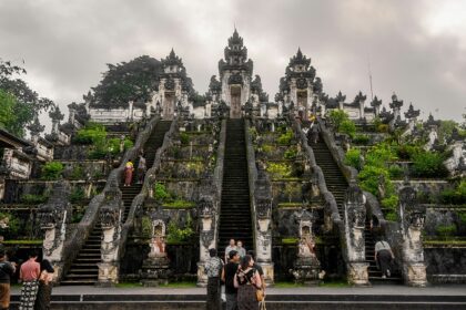 An image of a person standing at the entrance of the iconic Lempuyang Temple in Bali.