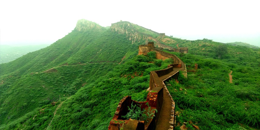 A view of long ramparts that enclose the fort and are surrounded by greenery