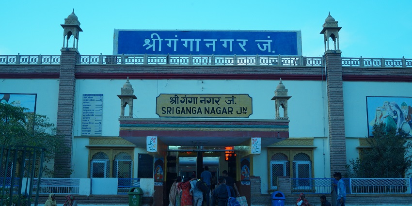 The entrance of Sriganganagar junction, filled with travellers waiting and carrying luggage