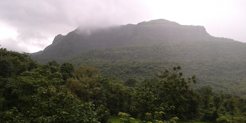 Chandragad Fort in Sahyadri mountains, Maharashtra, overlooking lush landscape.