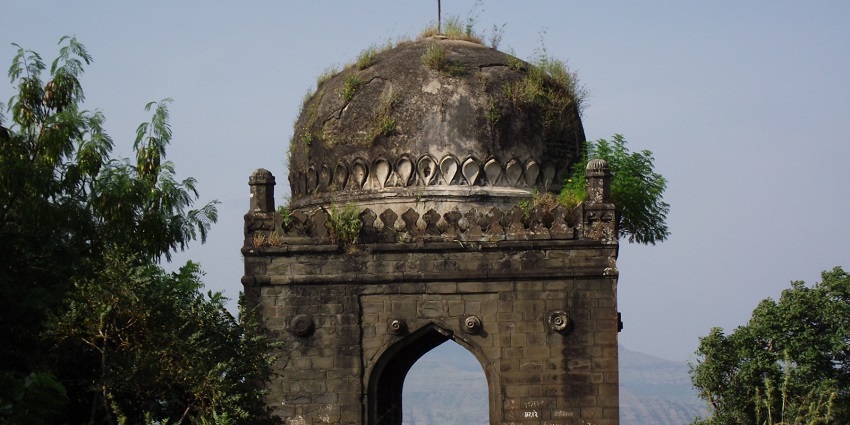 Scenic view of the Shivneri Fort's entrance with surrounding greenery and rugged terrain