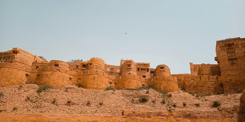 View of the well-lit Jaisalmer Fort in the background, offering stunning views of the city