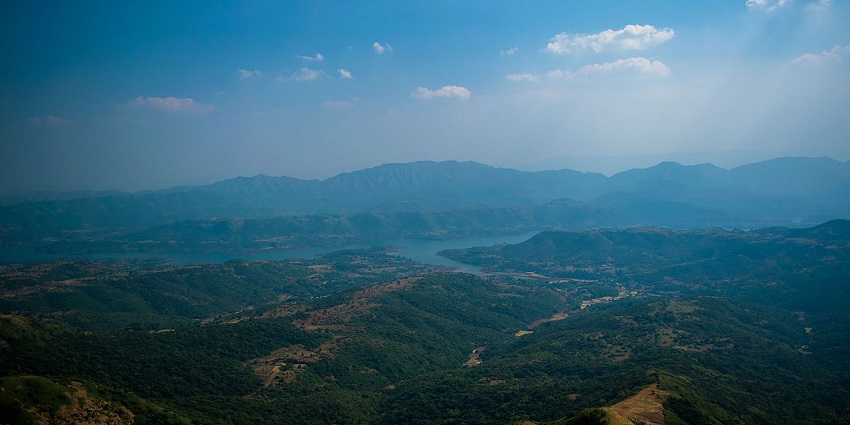 An aerial view of Maharashtra, showcasing diverse geography surrounded by green landscapes.