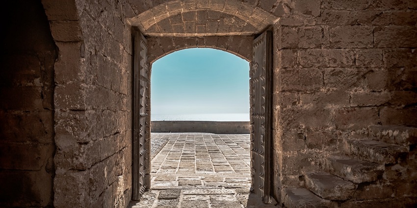 Close-up of an old wooden door in a historic stone fort with intricate architecture