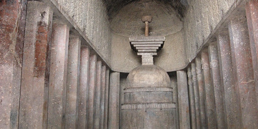 Inside the walls of Bahrot caves, with tall stone walls , pillars and idols