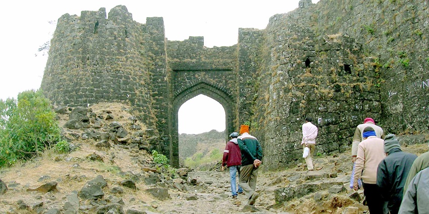 Gavilgad Fort entry gate offers historic architecture and stunning views of nature.