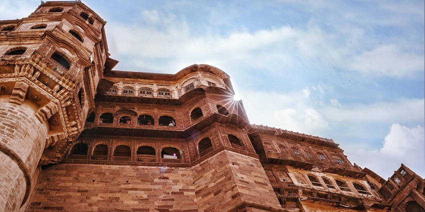 An image showing a striking low-angle view of a brown concrete building, echoing Gorakhgad Fort