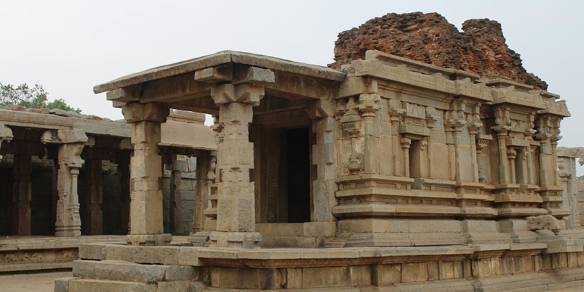 A majestic ancient temple featuring tall stone pillars, surrounded by a hushed landscape