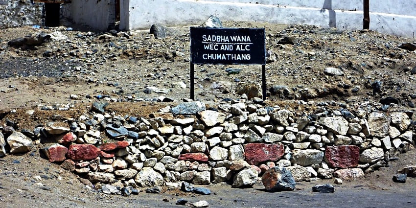 A picture of A signboard near the Chumathang Hot Spring highlighting the entrance to the Chumathang village