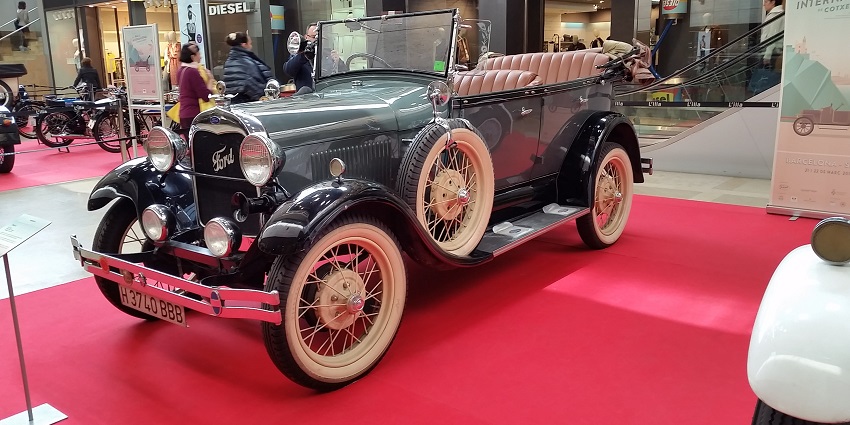 A fancy, antique car on display in the Vinatge car museum