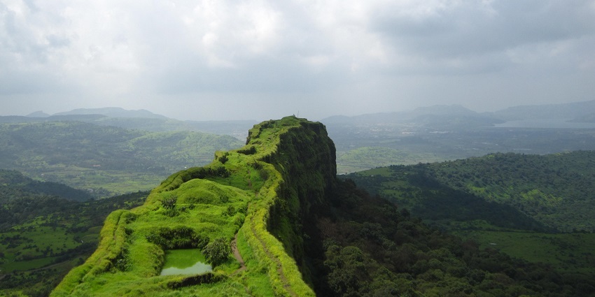 View of Lohagad fort, a popular fort near Visapur fort, surrounded by greenery.
